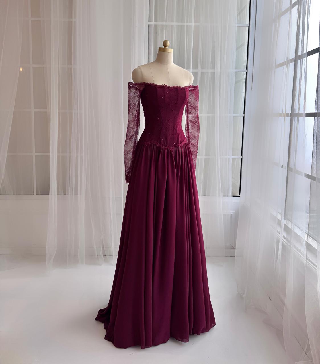 Red A-Line gown with long off the shouler sleeves and lace