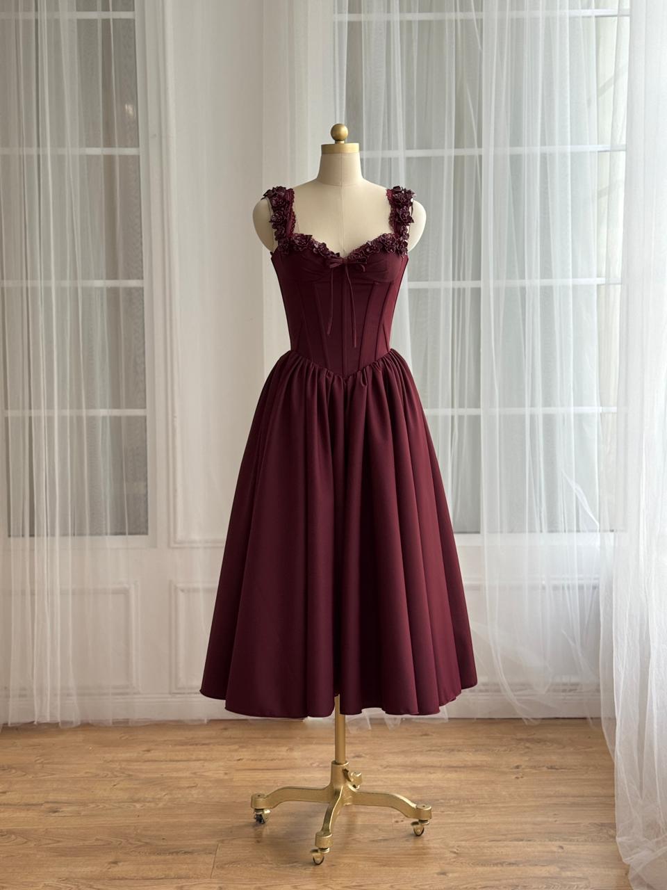 Burgundy midi dress with detailed bow and embroidered straps