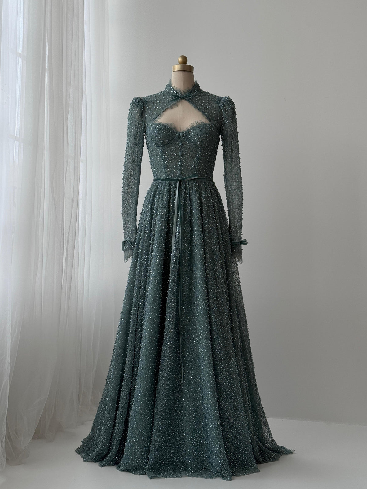Turquoise A-Line gown with long sleeve, bolero, beading and embroidered bows