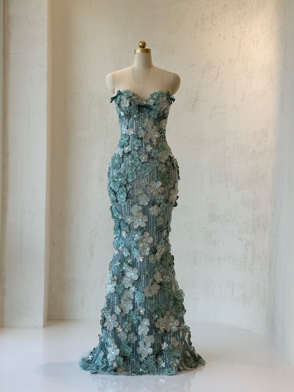 Turquoise mermaid gown with embroidered flowers and no sleeves