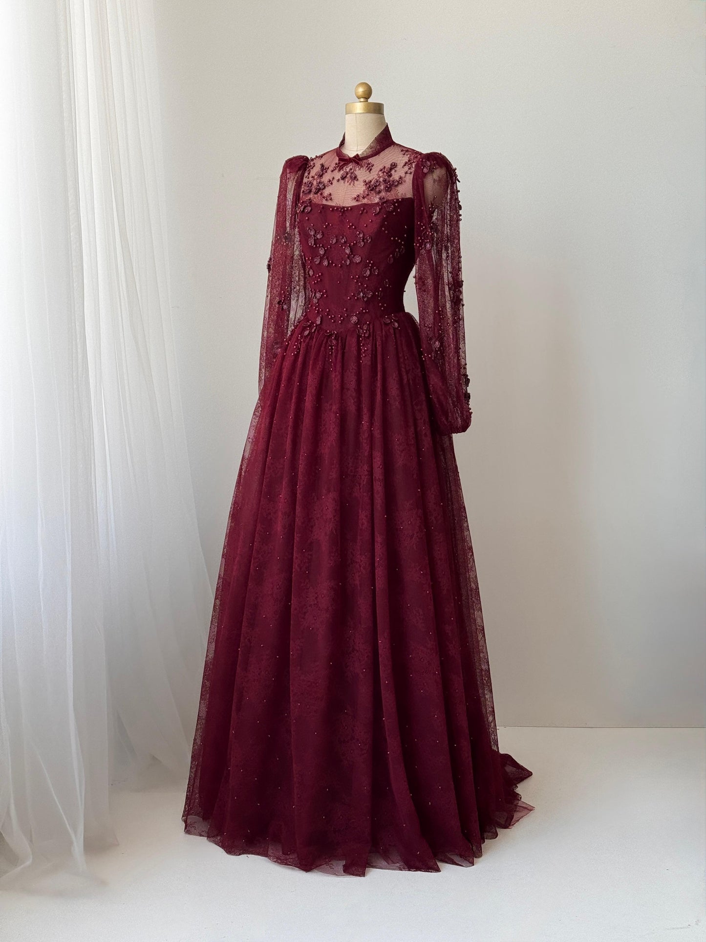Burgundy A-Line gown with long sleeves and embroidered work