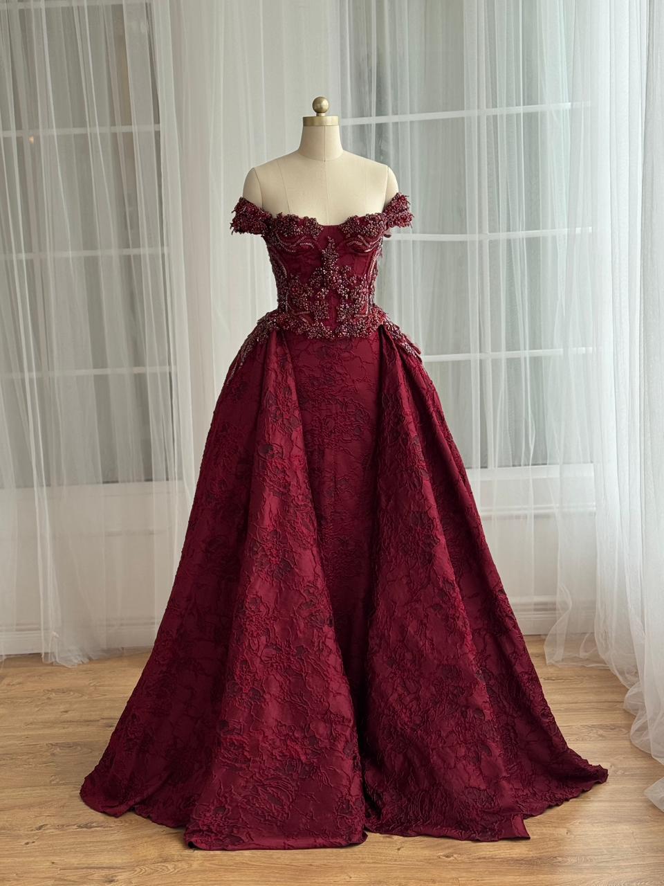 Red A-Line gown with overskirt, off the shoulder sleeves and embroidery