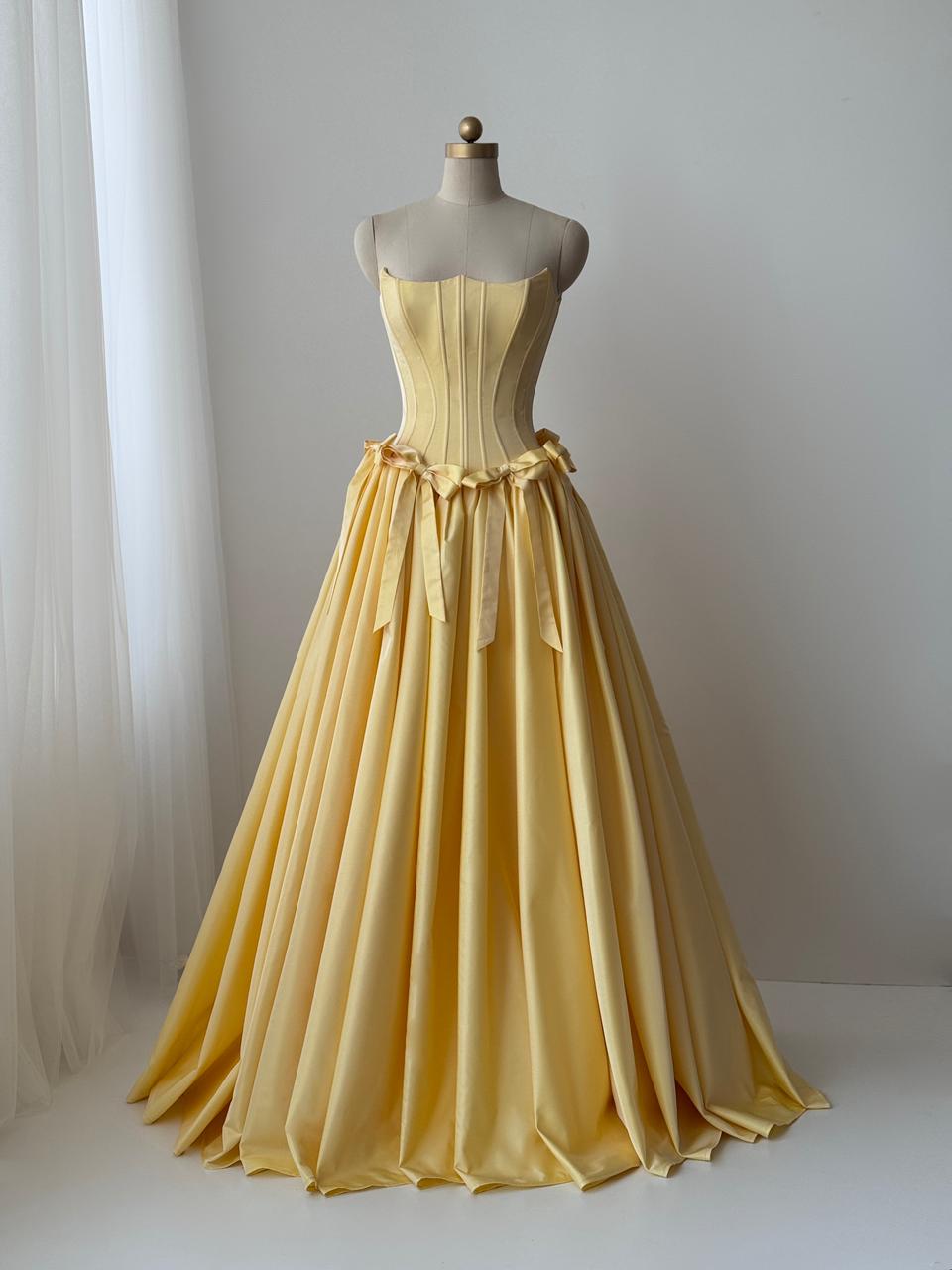 Yellow A-Line gown with embroidered bows and no sleeves