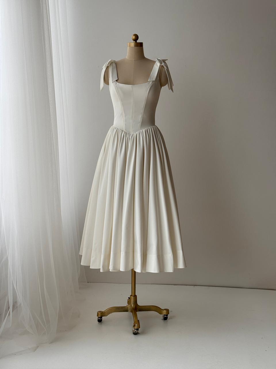 White bridal midi dress with bow straps and taffeta fabric