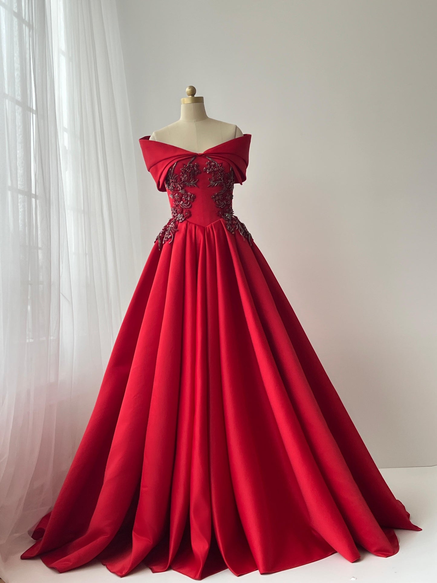 Red A-Line gown with off the shoulder sleeves and embroidery