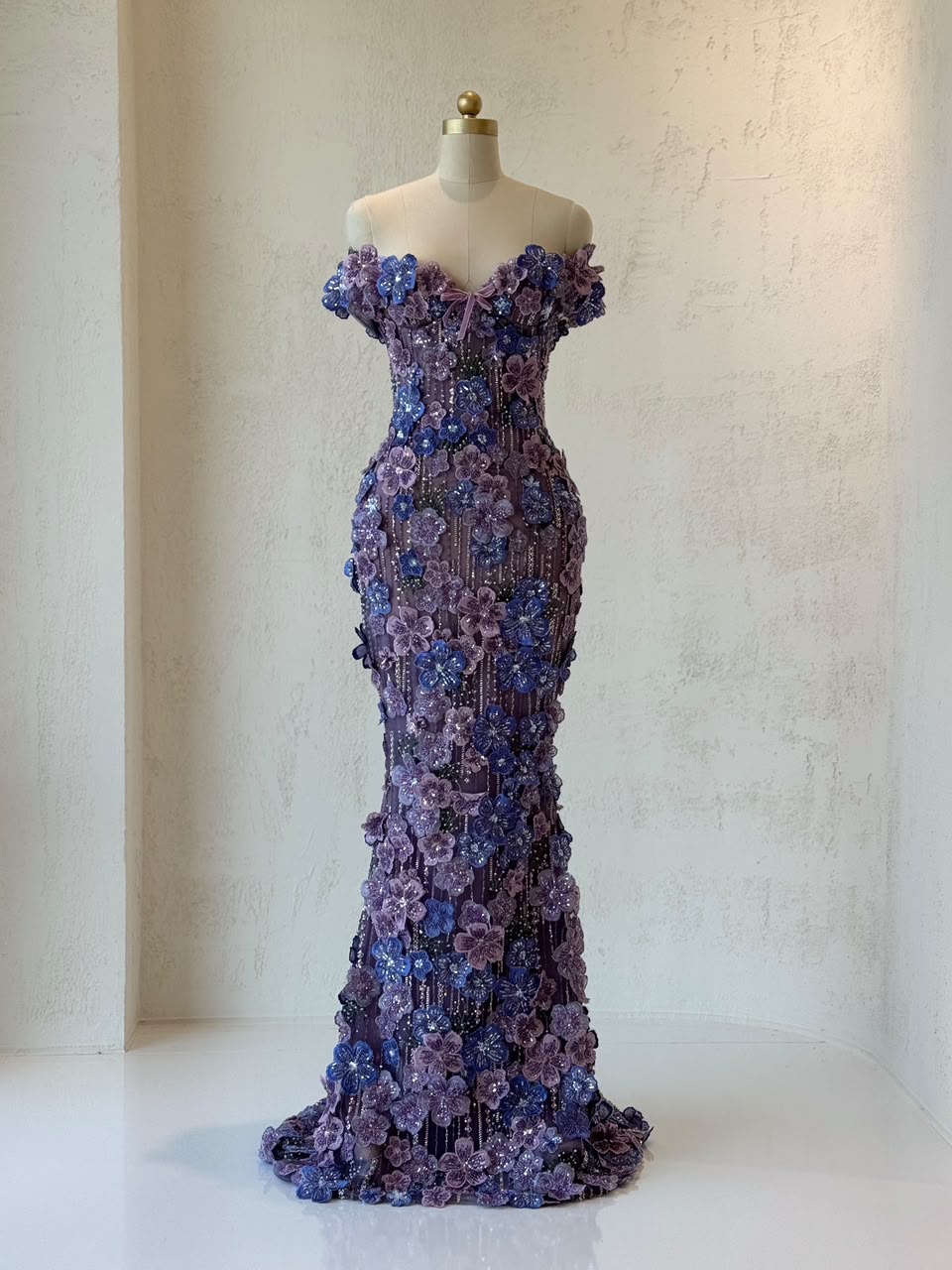 Purple mermaid gown with of the shoulder sleeves and embroidered flowers