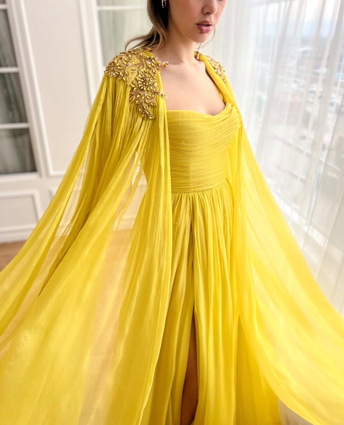 Yellow A-Line dress with embroidery and cape sleeves