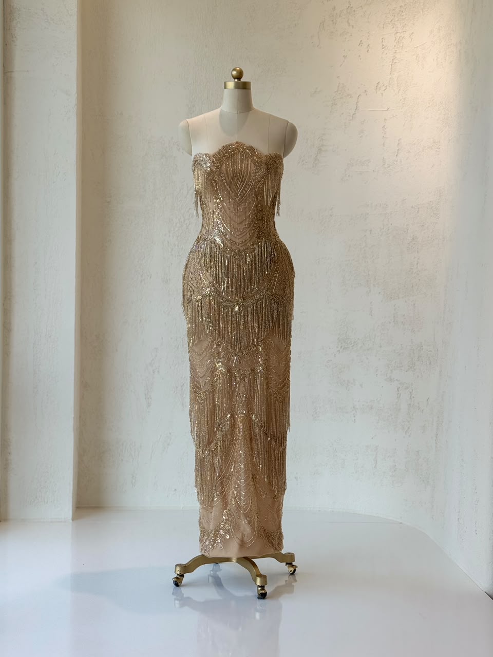 Gold mermaid gown with no sleeves and fringes