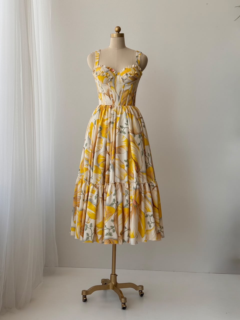 Yellow midi dress with printed floral fabric, straps and embroidered work