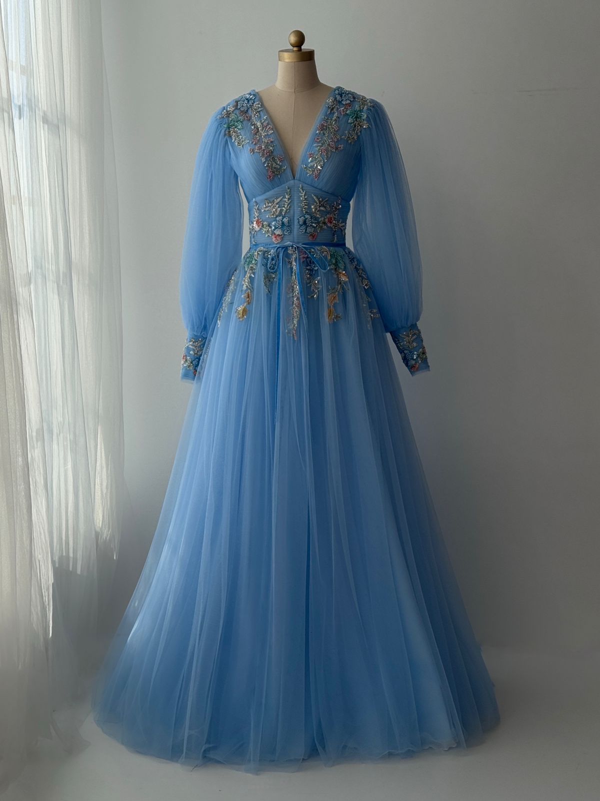 Blue A-Line gown with long sleeves, v-neck and embroidery