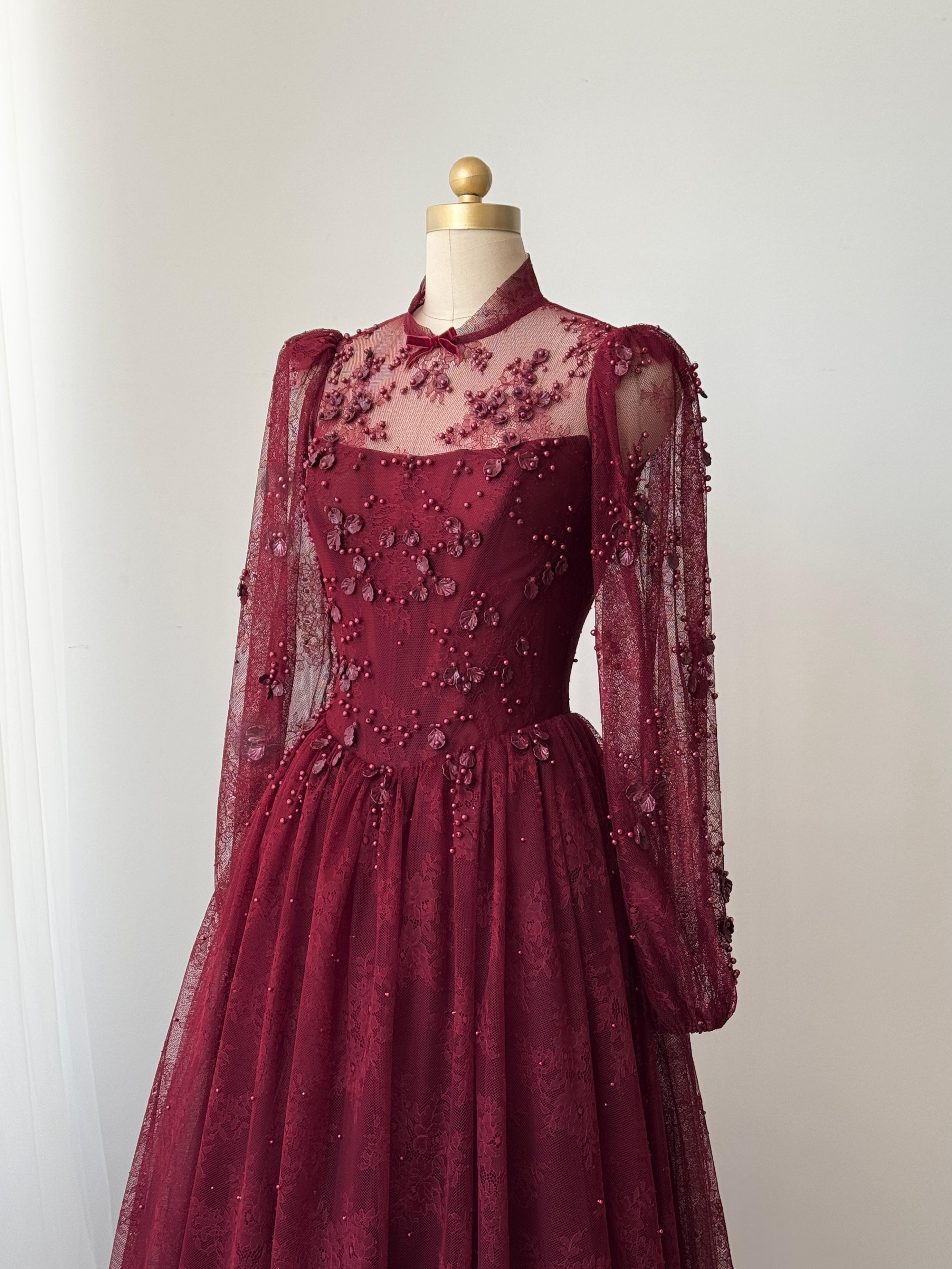 Burgundy A-Line gown with long sleeves and embroidered work