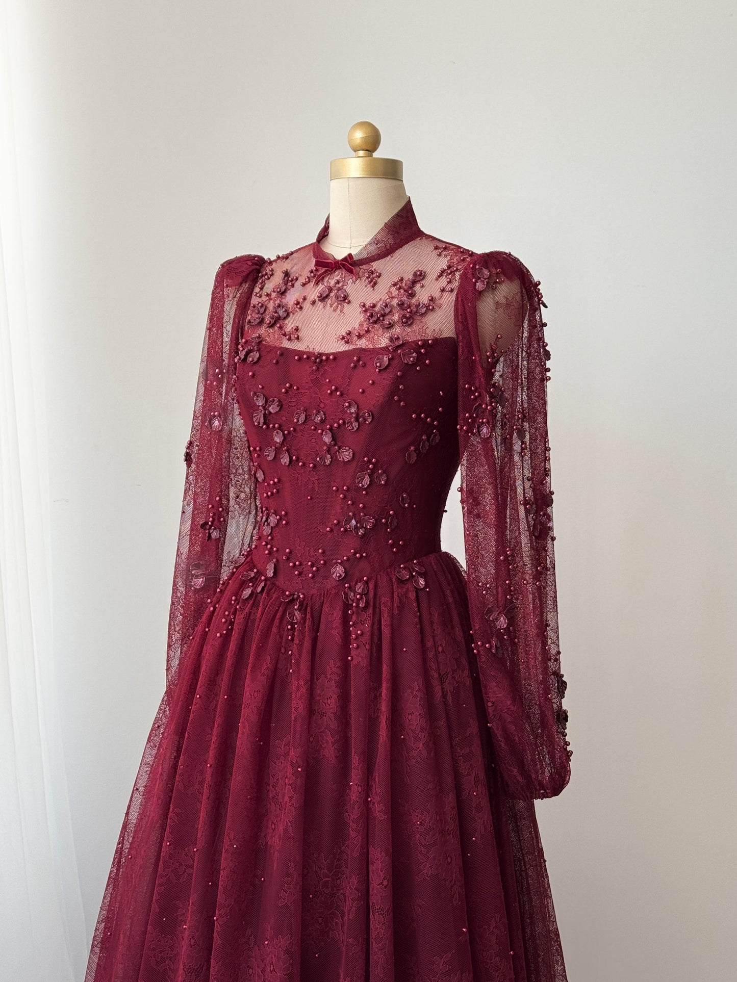 Burgundy A-Line gown with long sleeves and embroidered work