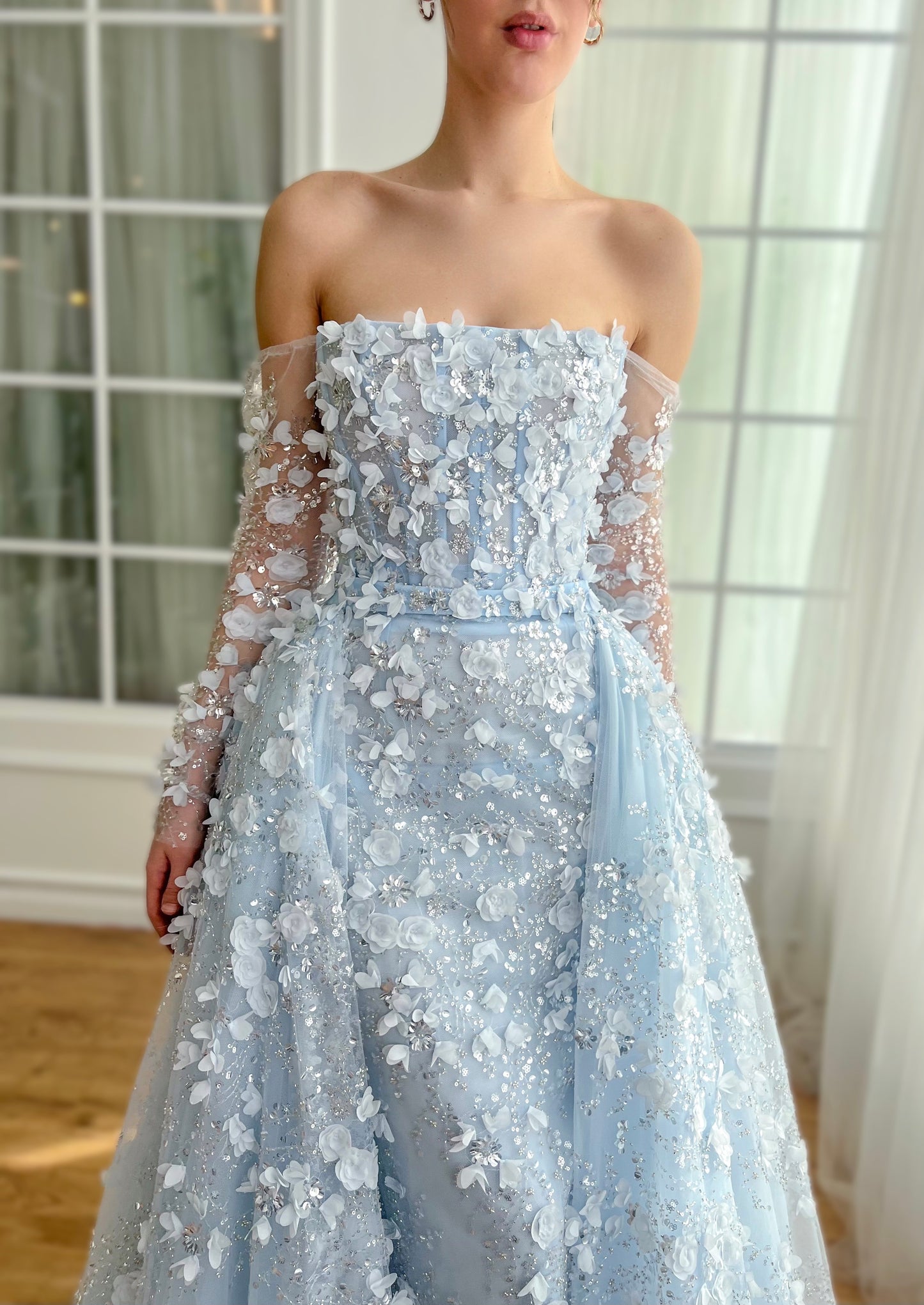 Light blue A-Line dress with long off the shoulder sleeves, overskirt and embroidery