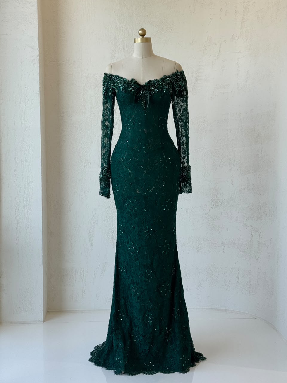Green mermaid gown with long off the shoulder sleeves, embroidery and lace