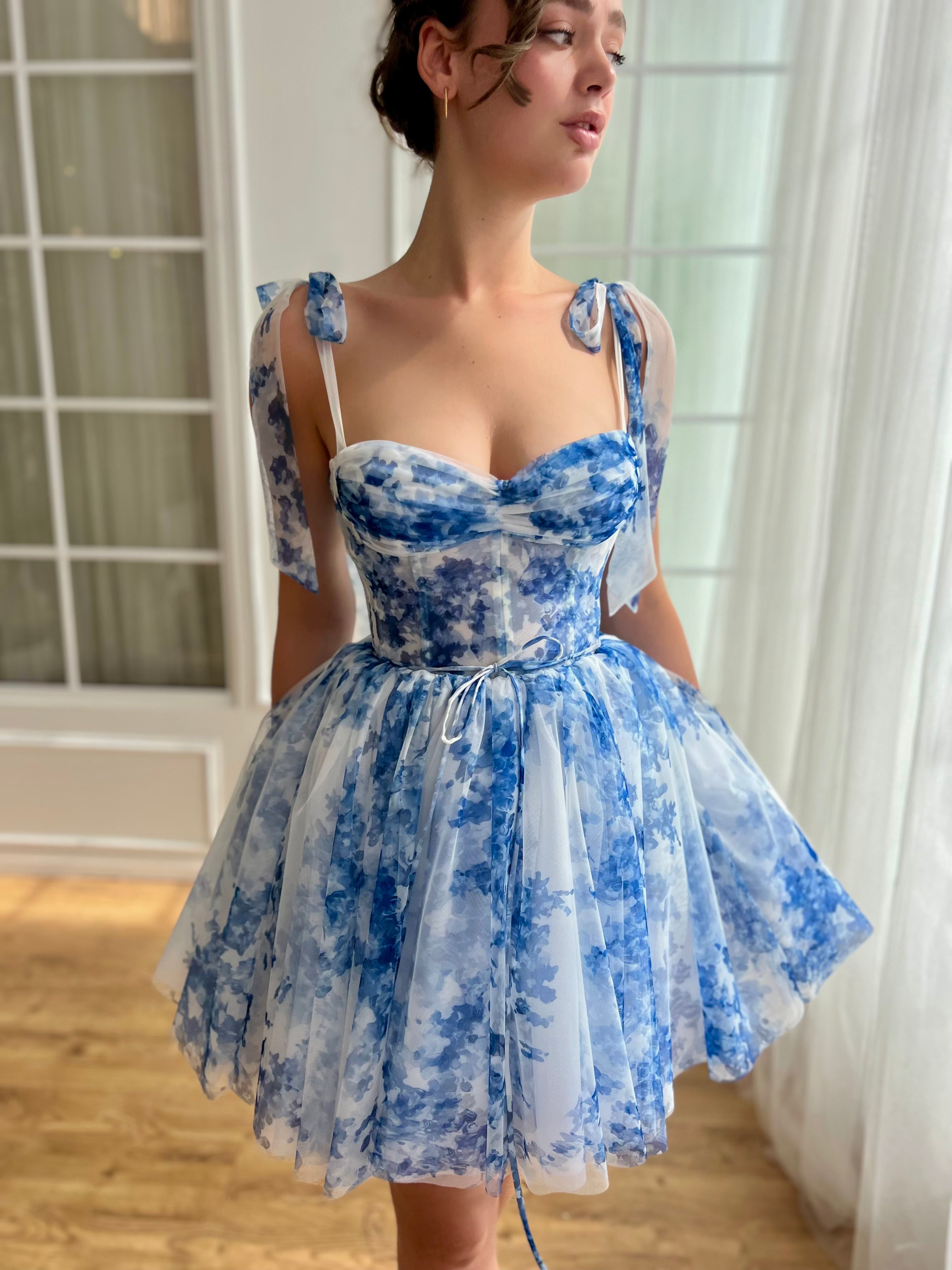Blue mini dress with off the shoulder sleeves and printed floral design