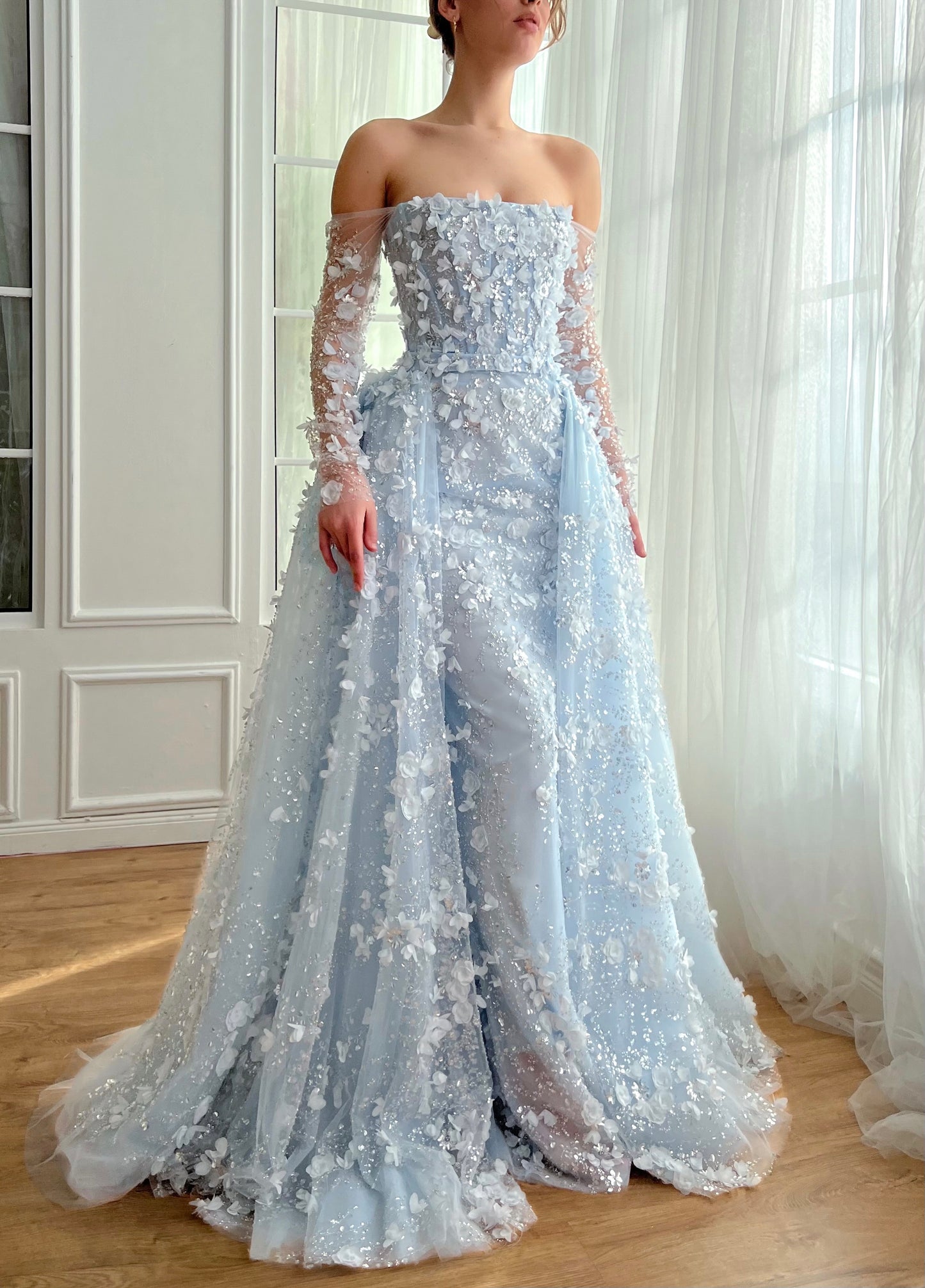 Light blue A-Line dress with long off the shoulder sleeves, overskirt and embroidery