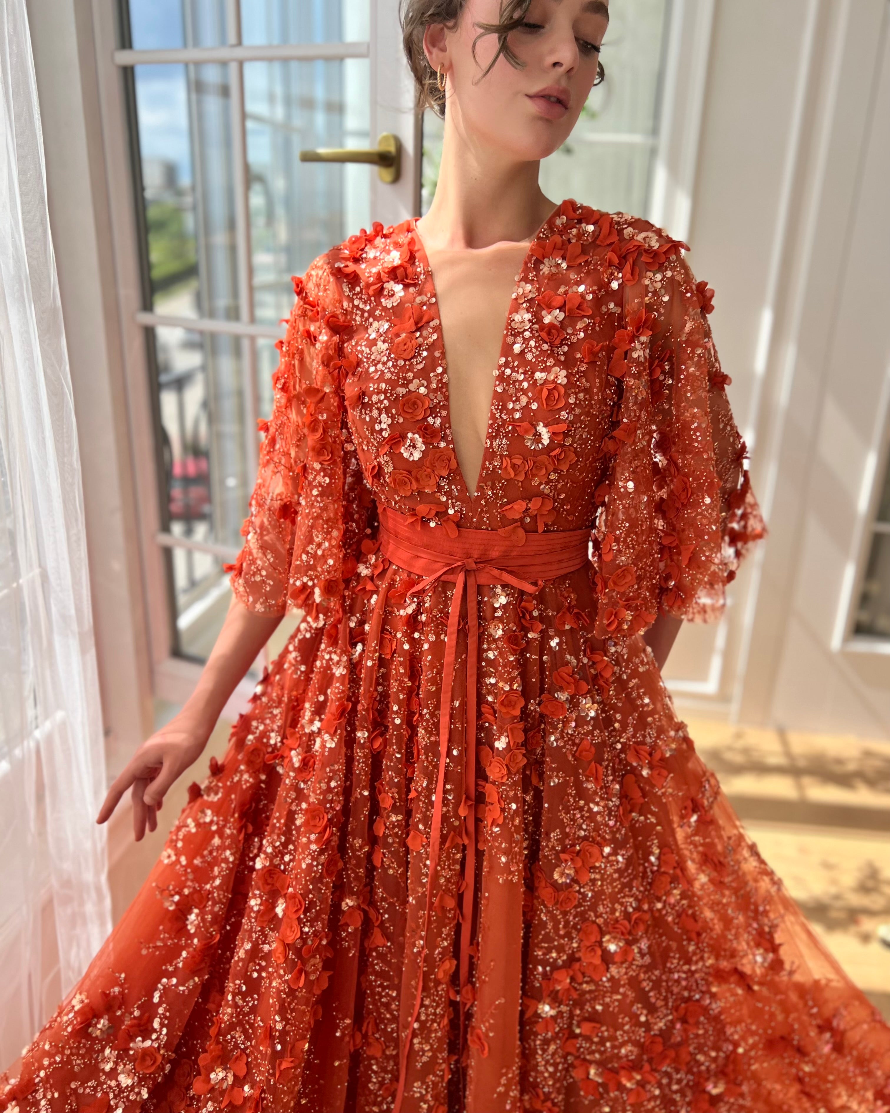 Orange a-line dress with flutter sleeves, v-neck and embroidery