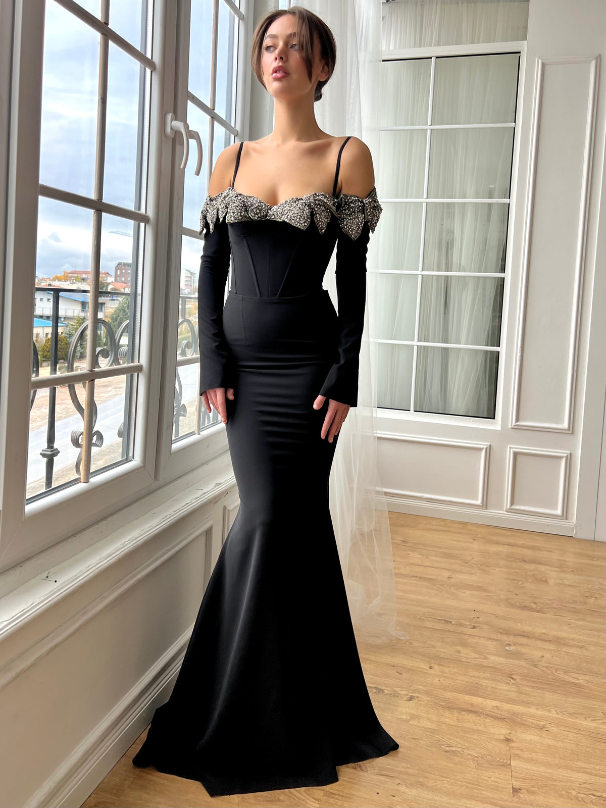 Black mermaid dress with long off the shoulder sleeves, spaghetti straps and embroidery