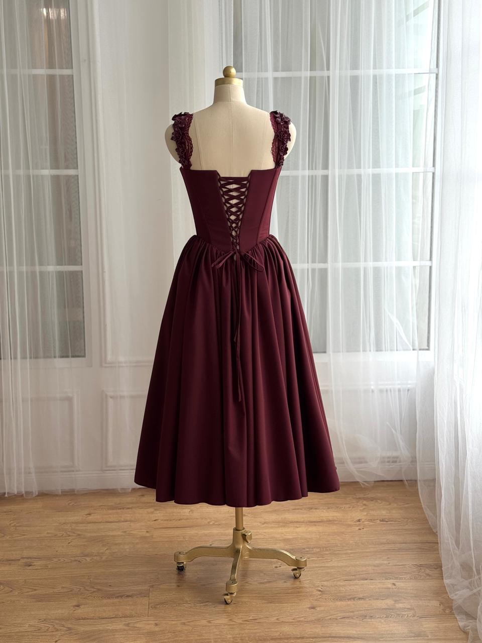 Burgundy midi dress with detailed bow and embroidered straps