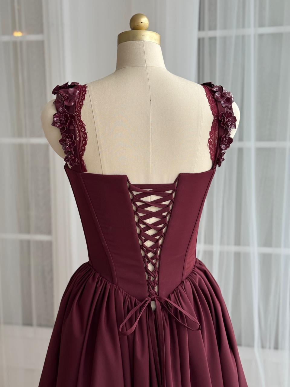Burgundy midi dress with detailed bow and embroidered straps