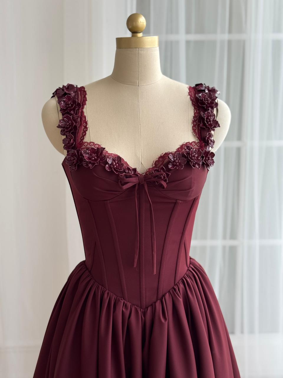 Burgundy midi dress with detailed bow and embroidered straps