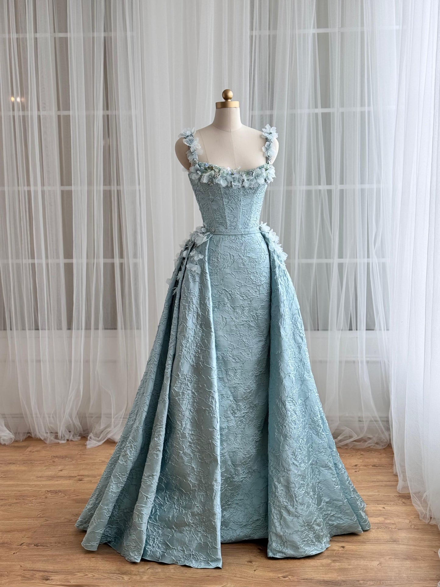 Blue A-Line gown with overskirt, straps and embroidered flowers
