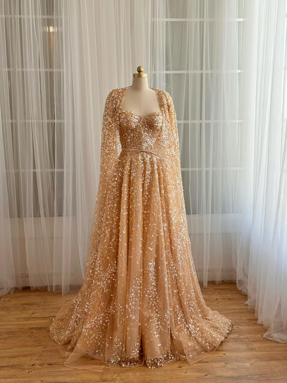 Beige A-Line gown with cape, no sleeves and sequins