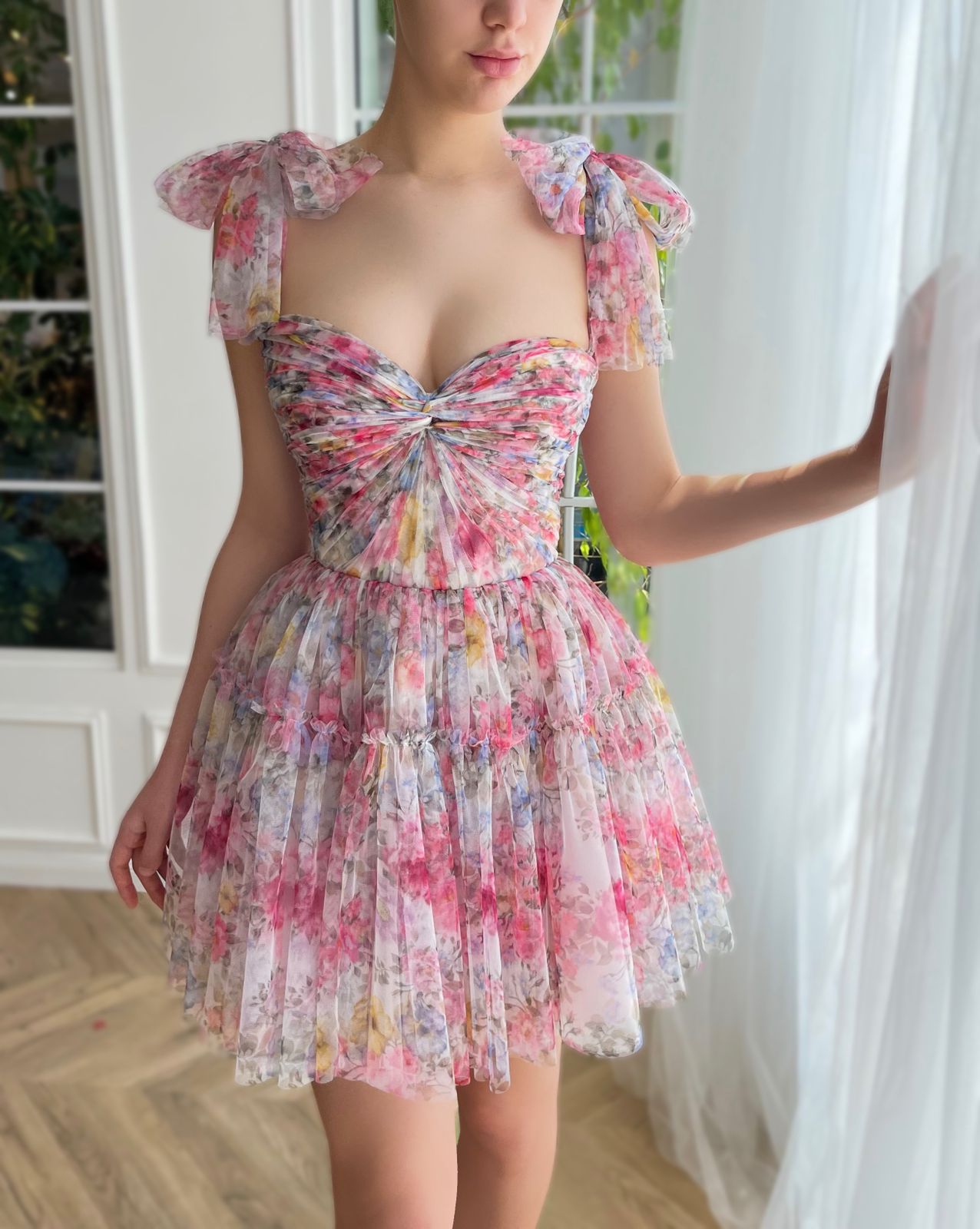 Pink mini dress with printed flowers and bow straps