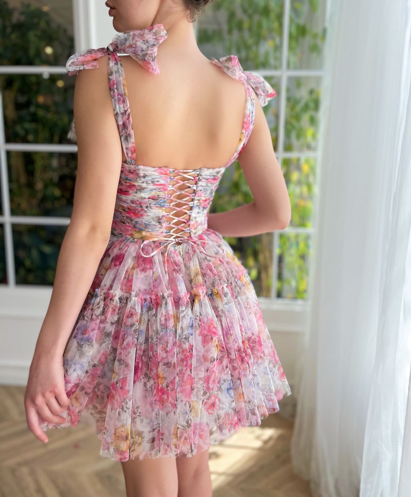 Pink mini dress with printed flowers and bow straps