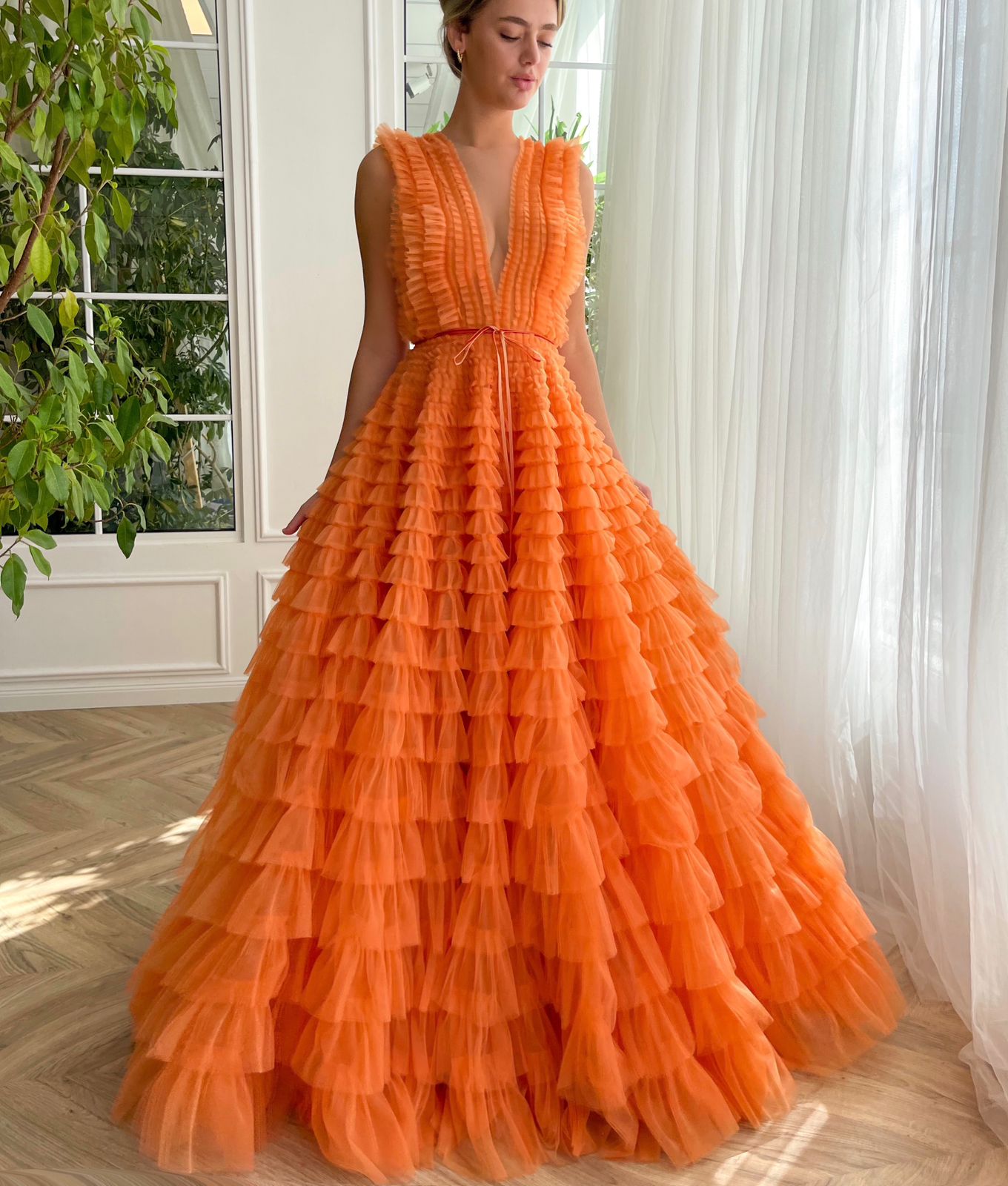 Orange A-Line dress with ruffles, no sleeves and v-neck