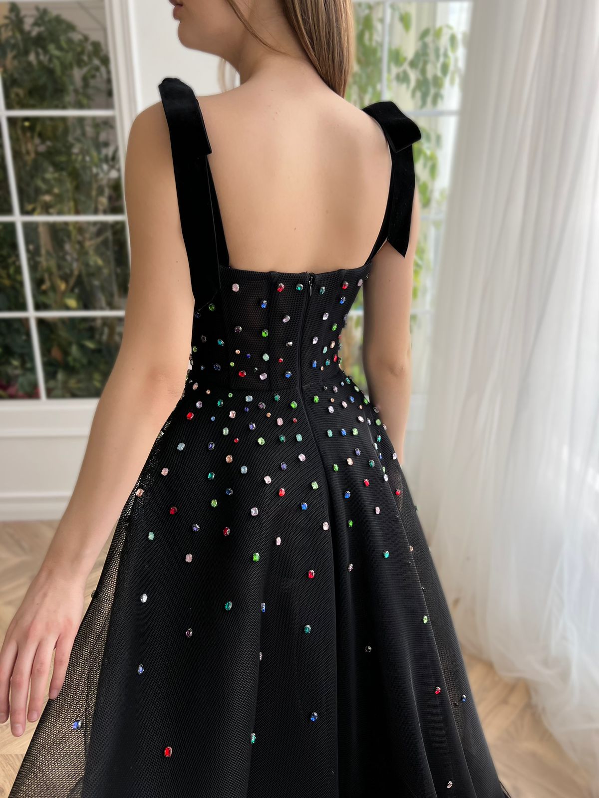 Black A-line dress with bow straps and embroidered jewels
