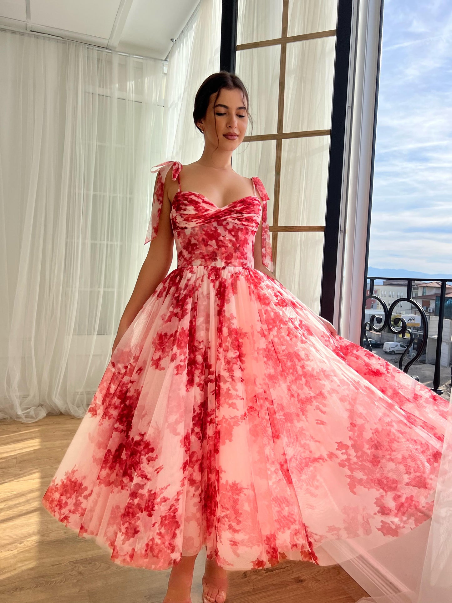 Red midi dress with bow straps and printed floral fabric