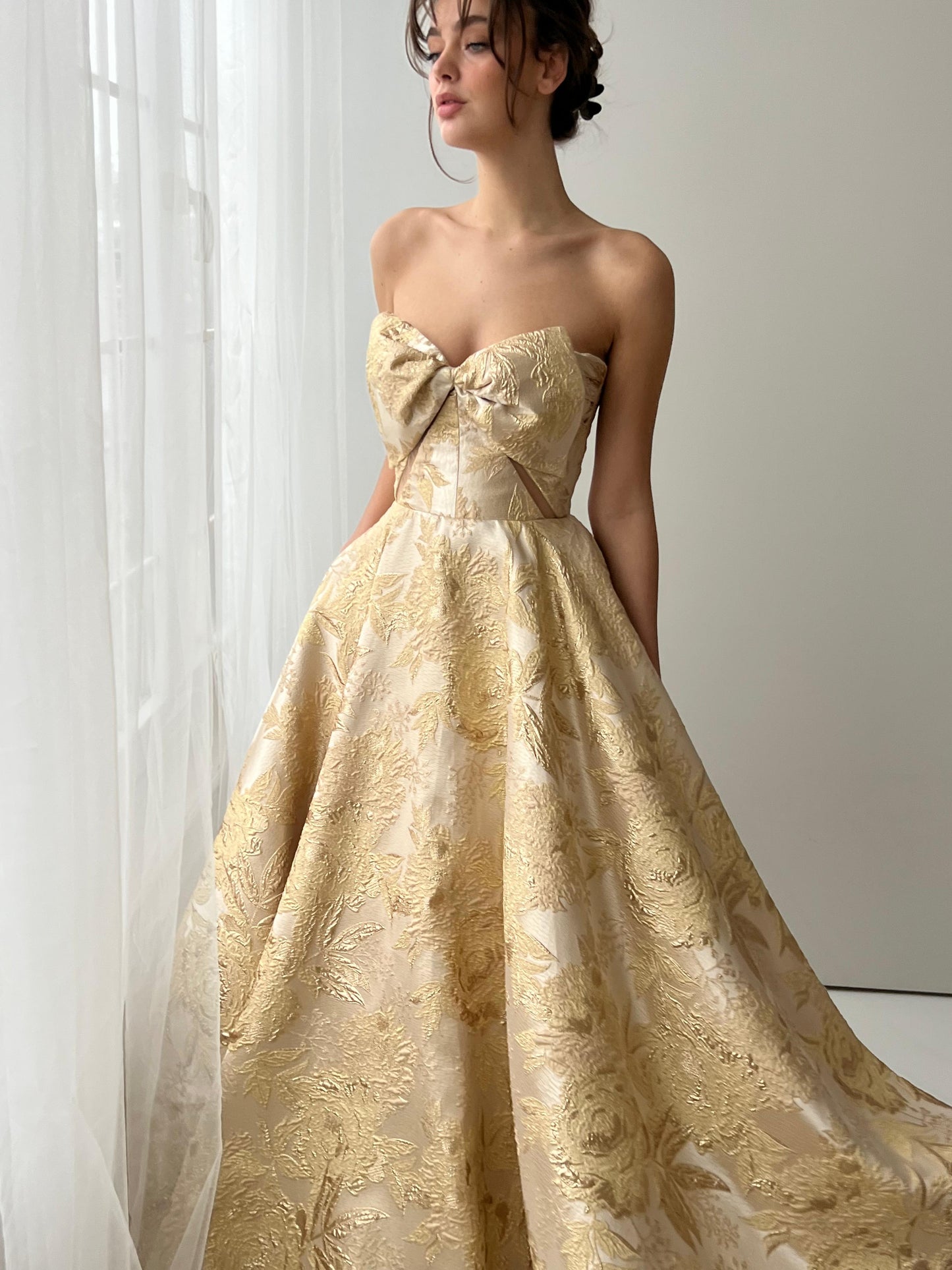 Beige A-Line dress with embroidered bow, brocade fabric and no sleeves