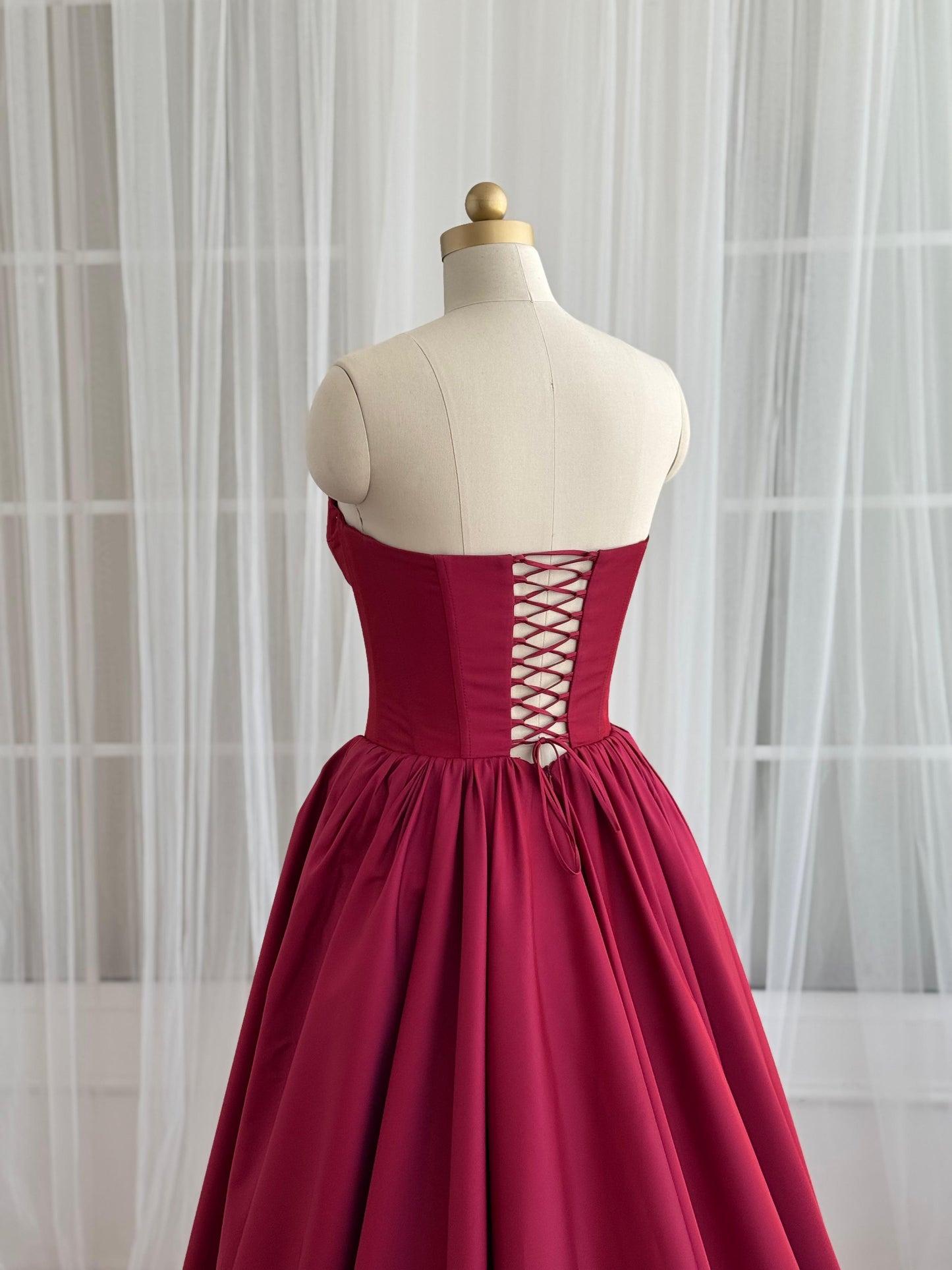 Red A-Line gown with no sleeves and taffeta fabric
