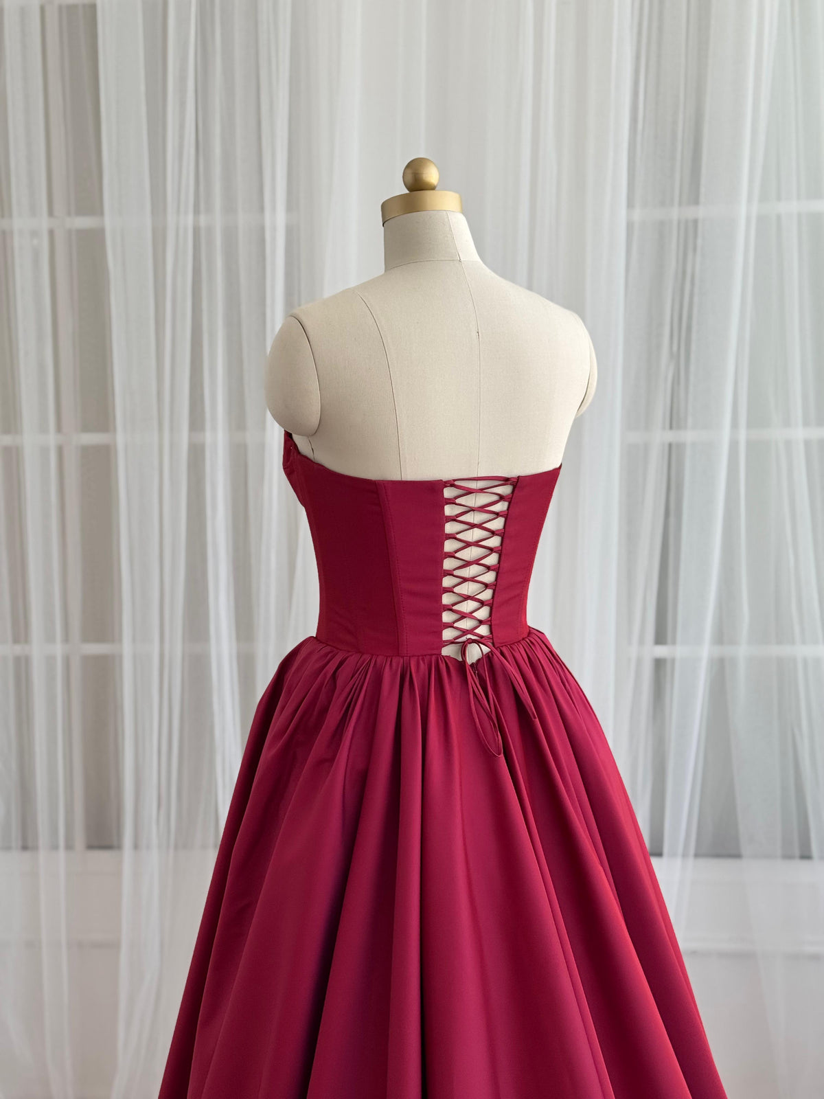 Red A-Line gown with no sleeves and taffeta fabric
