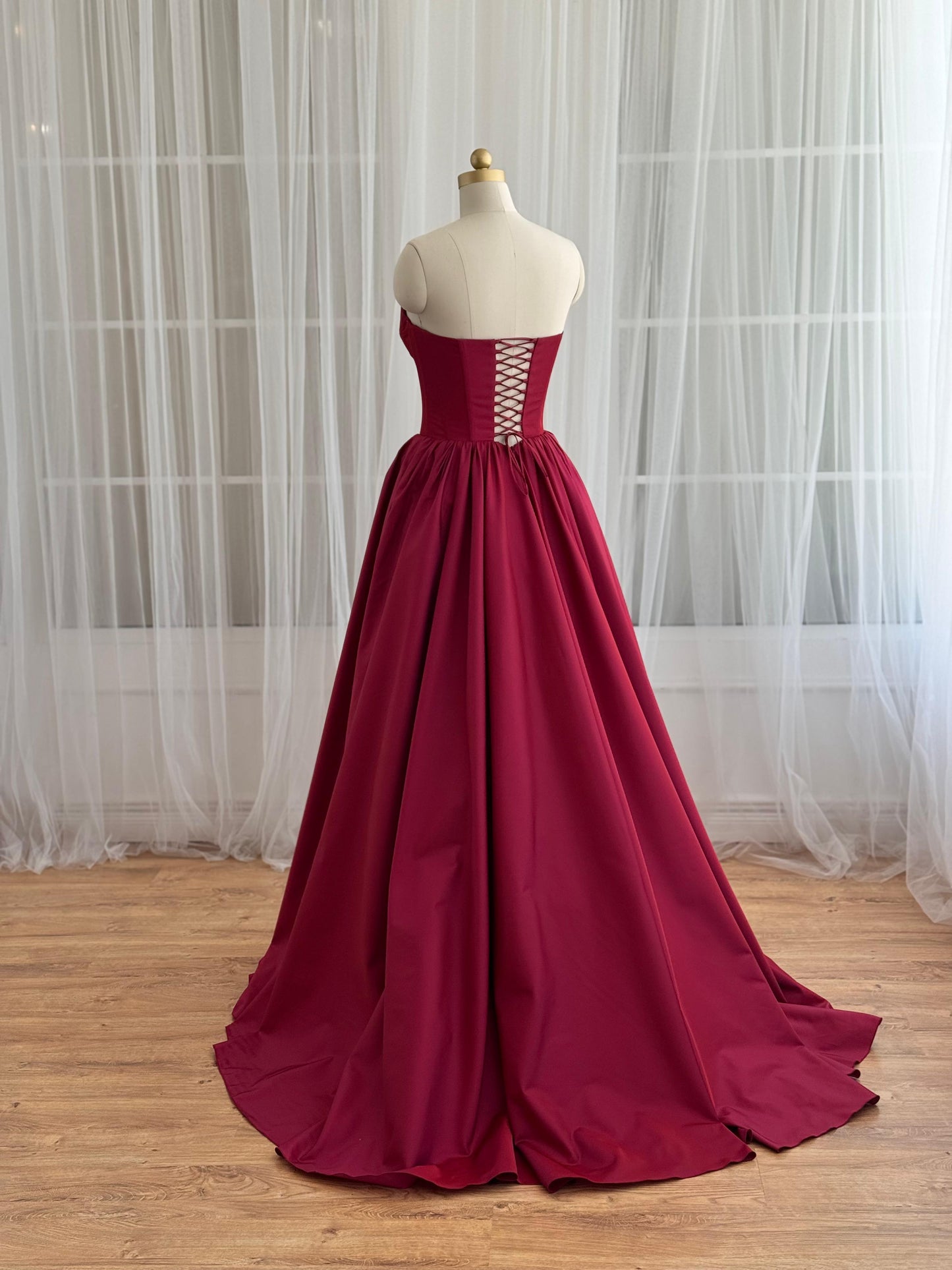 Red A-Line gown with no sleeves and taffeta fabric