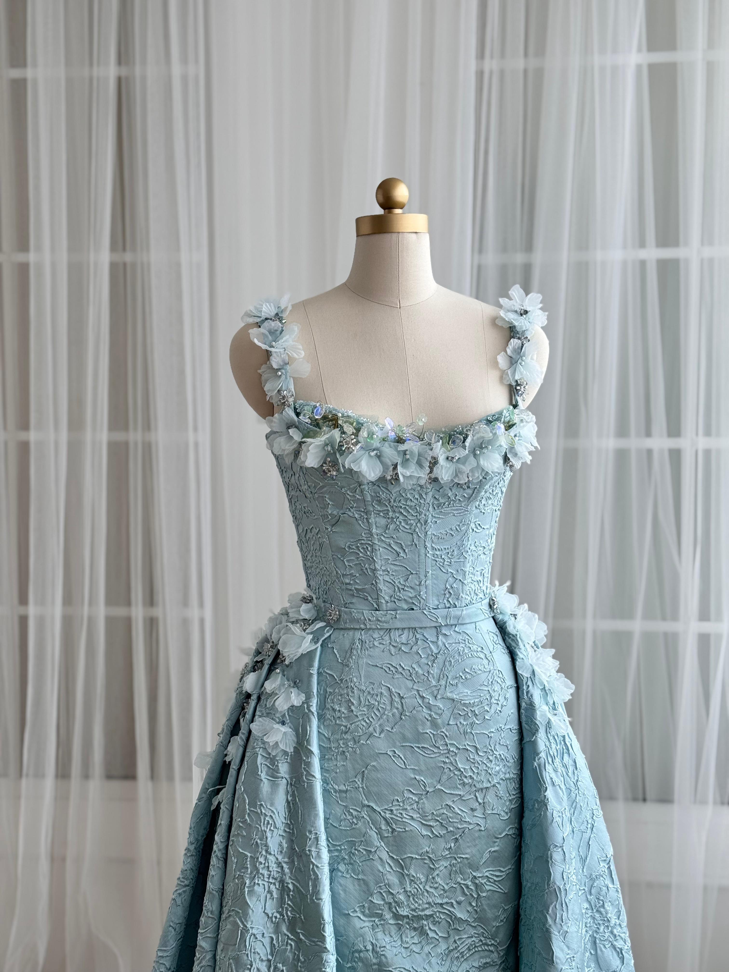 Blue A-Line gown with overskirt, straps and embroidered flowers