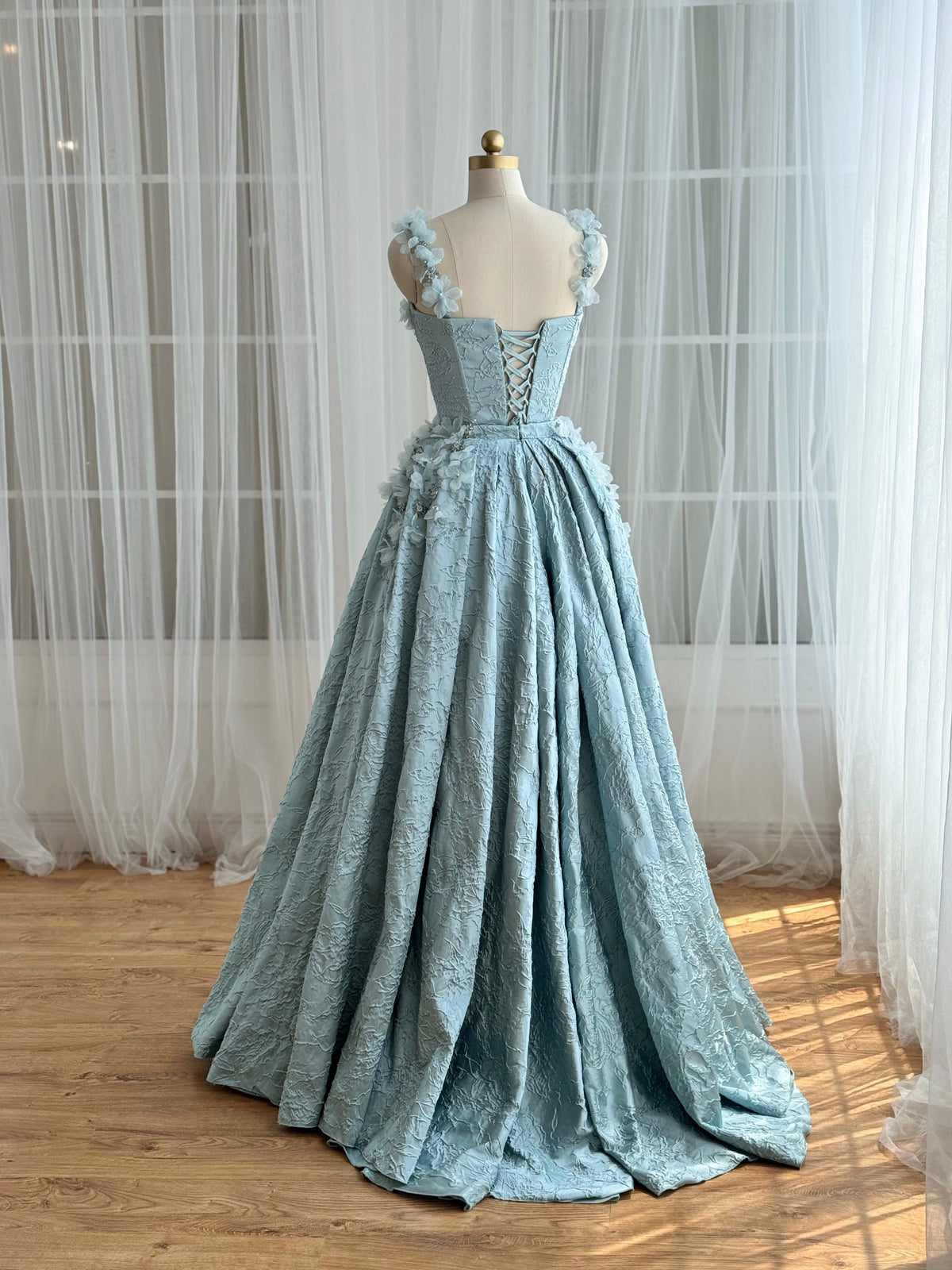 Blue A-Line gown with overskirt, straps and embroidered flowers