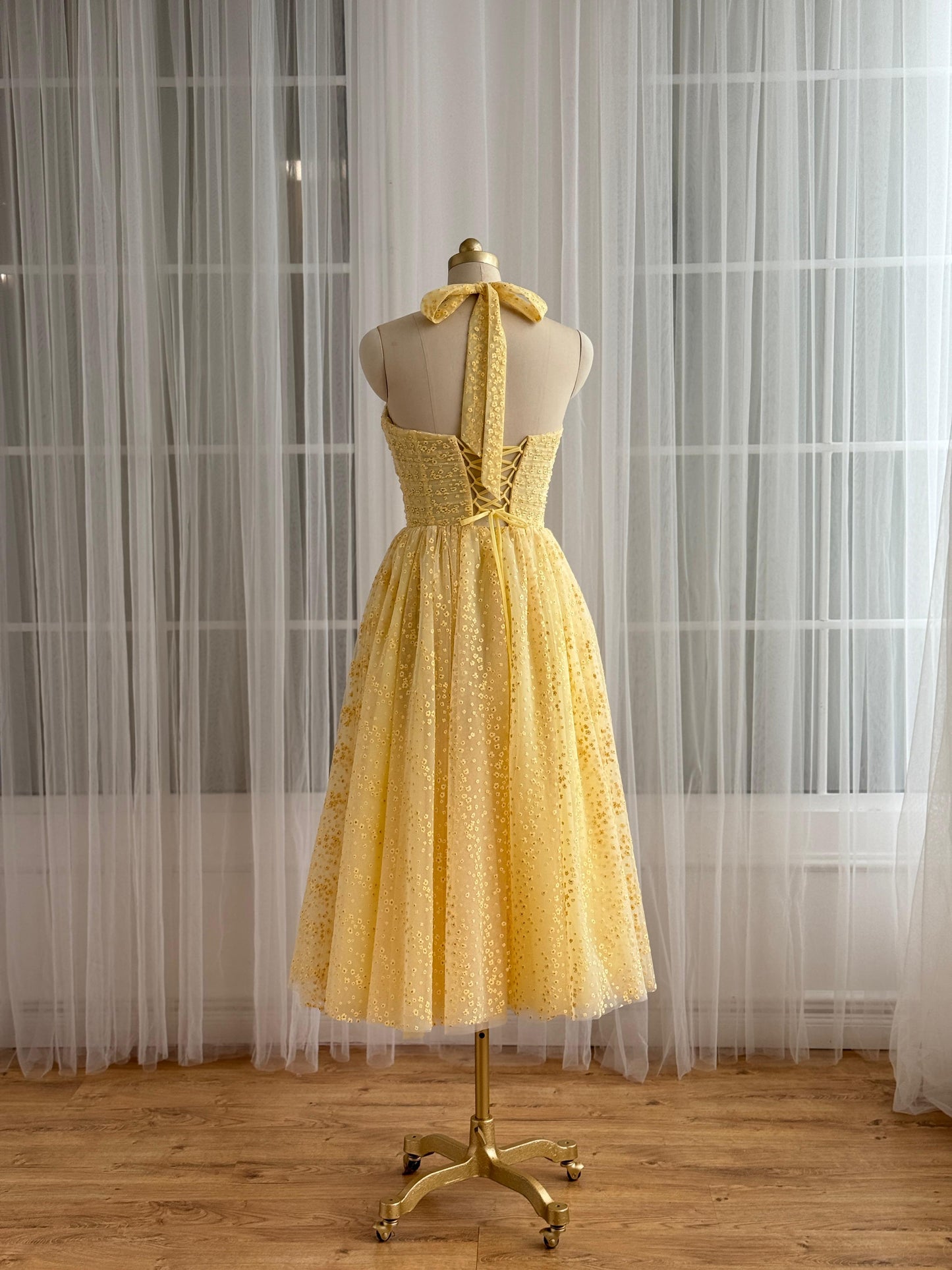 Yellow midi dress with straps and embroidered bow