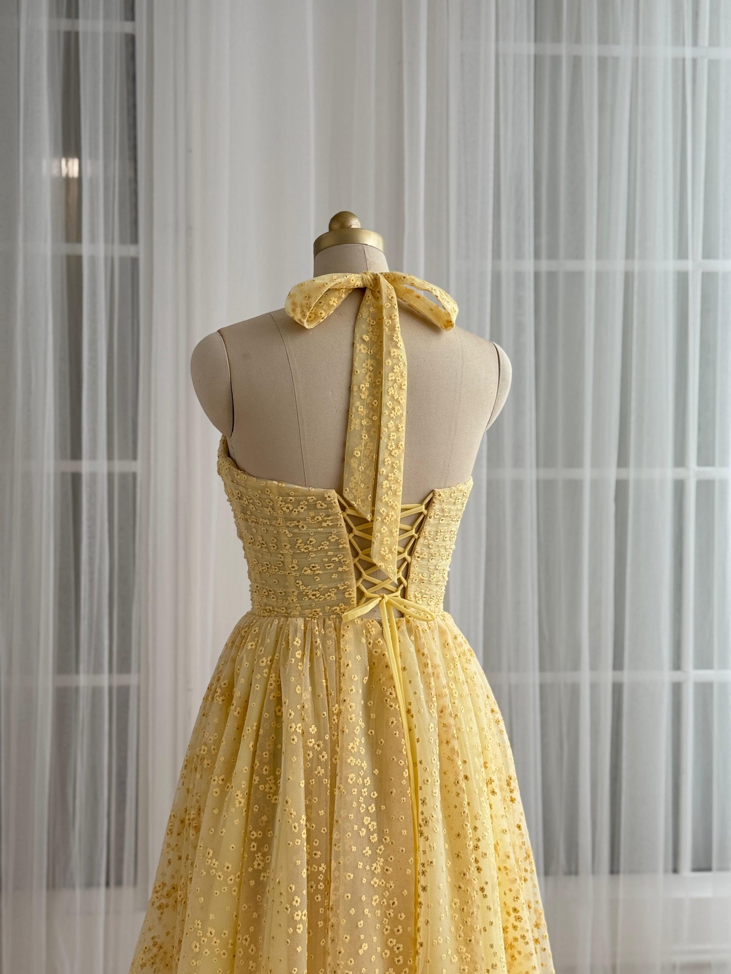 Yellow midi dress with straps and embroidered bow