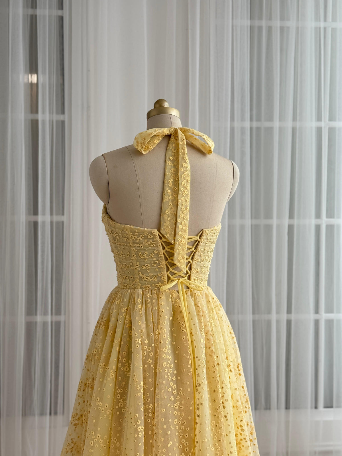 Yellow midi dress with straps and embroidered bow