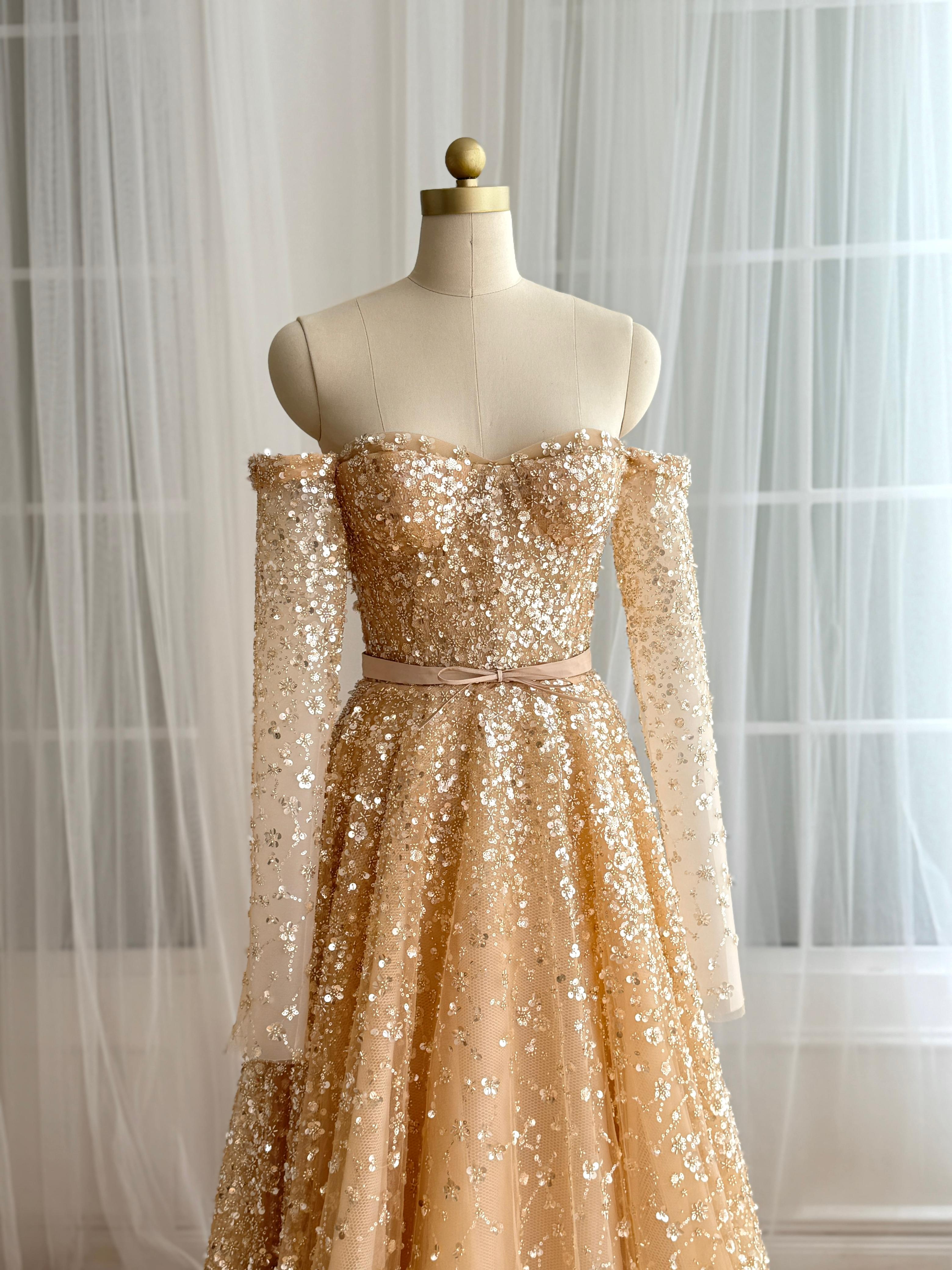 Beige A-Line dress with long off the shoulder sleeves and sequins