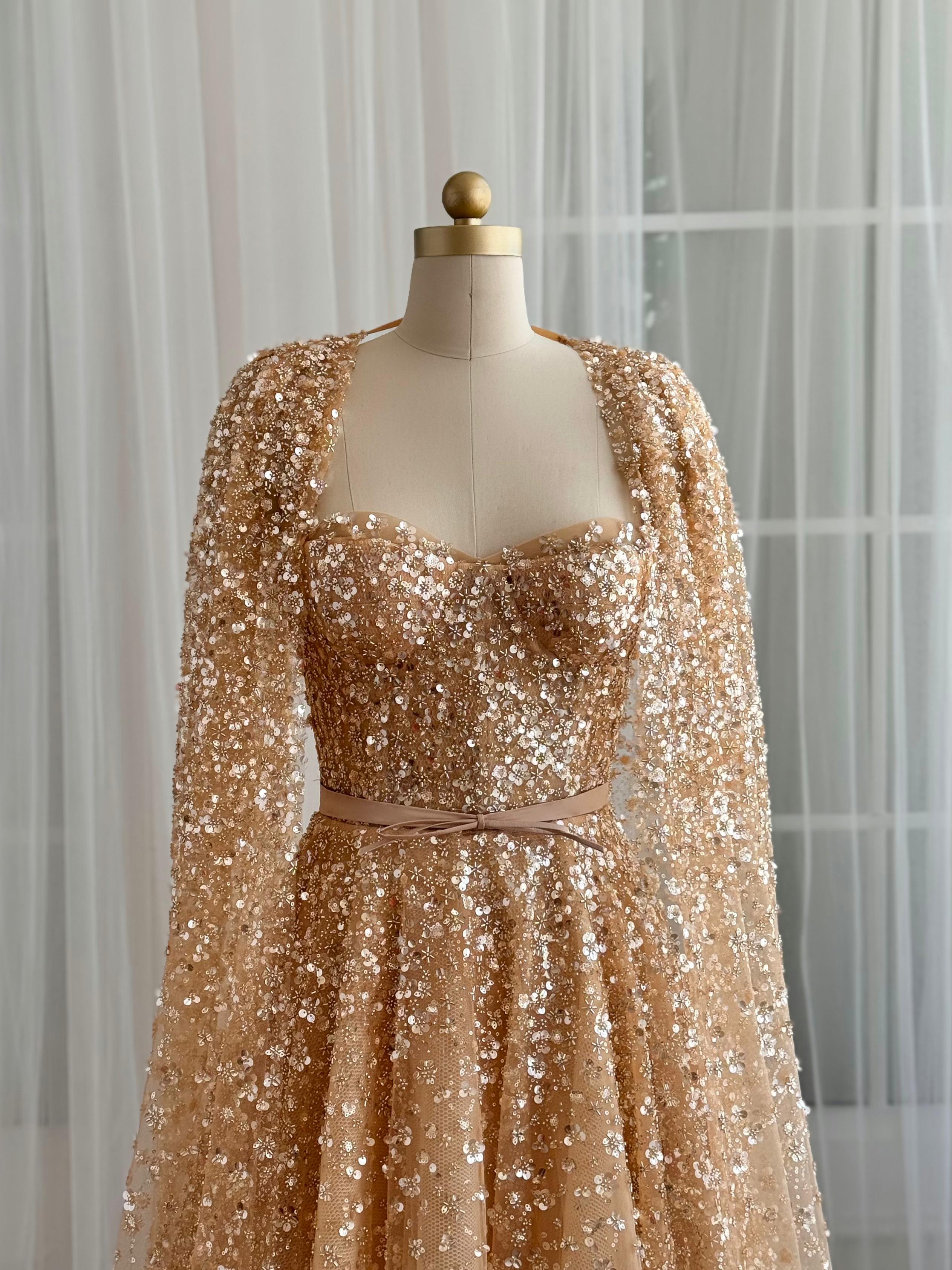 Beige A-Line gown with cape, no sleeves and sequins