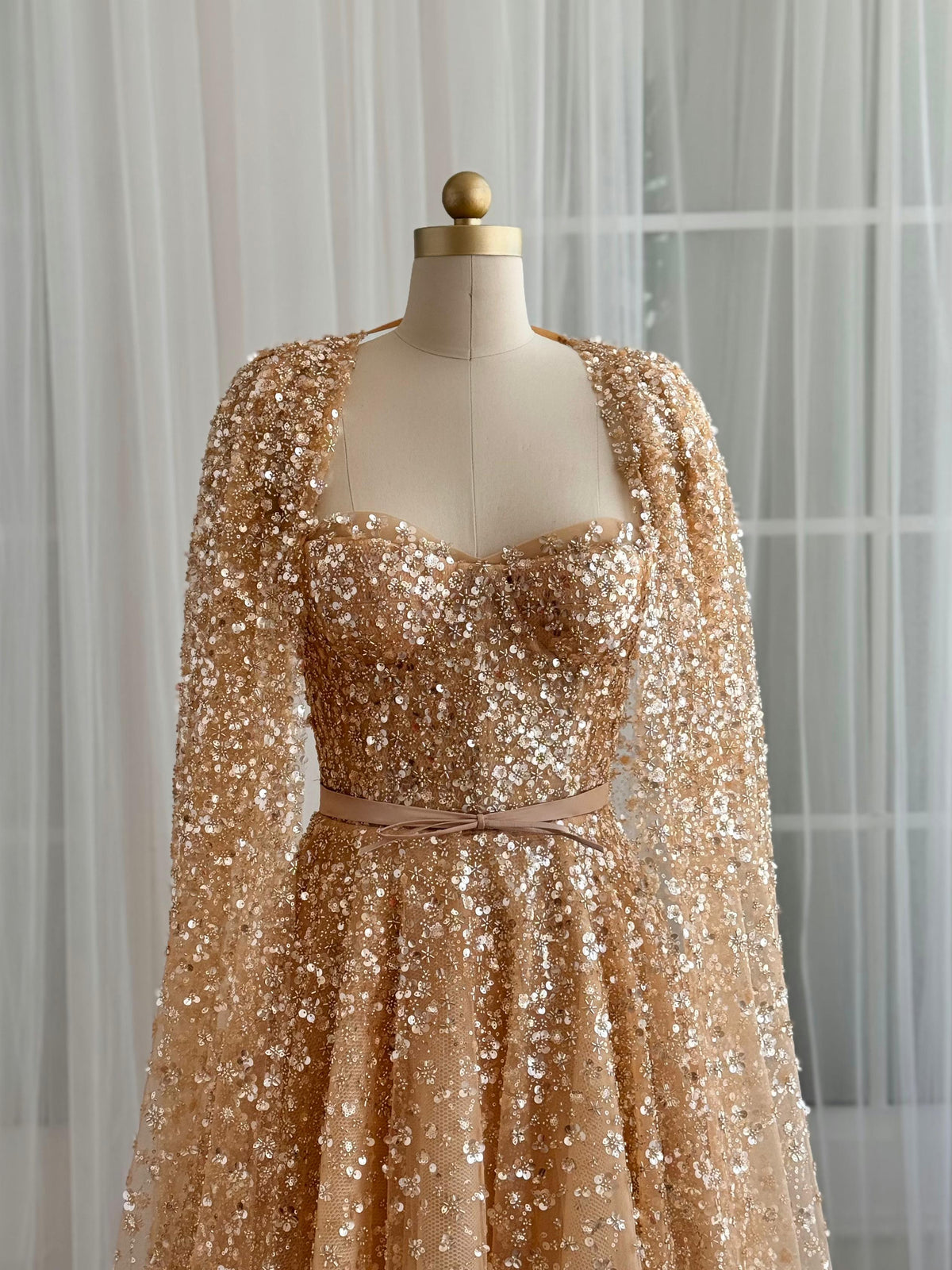 Beige A-Line gown with cape, no sleeves and sequins