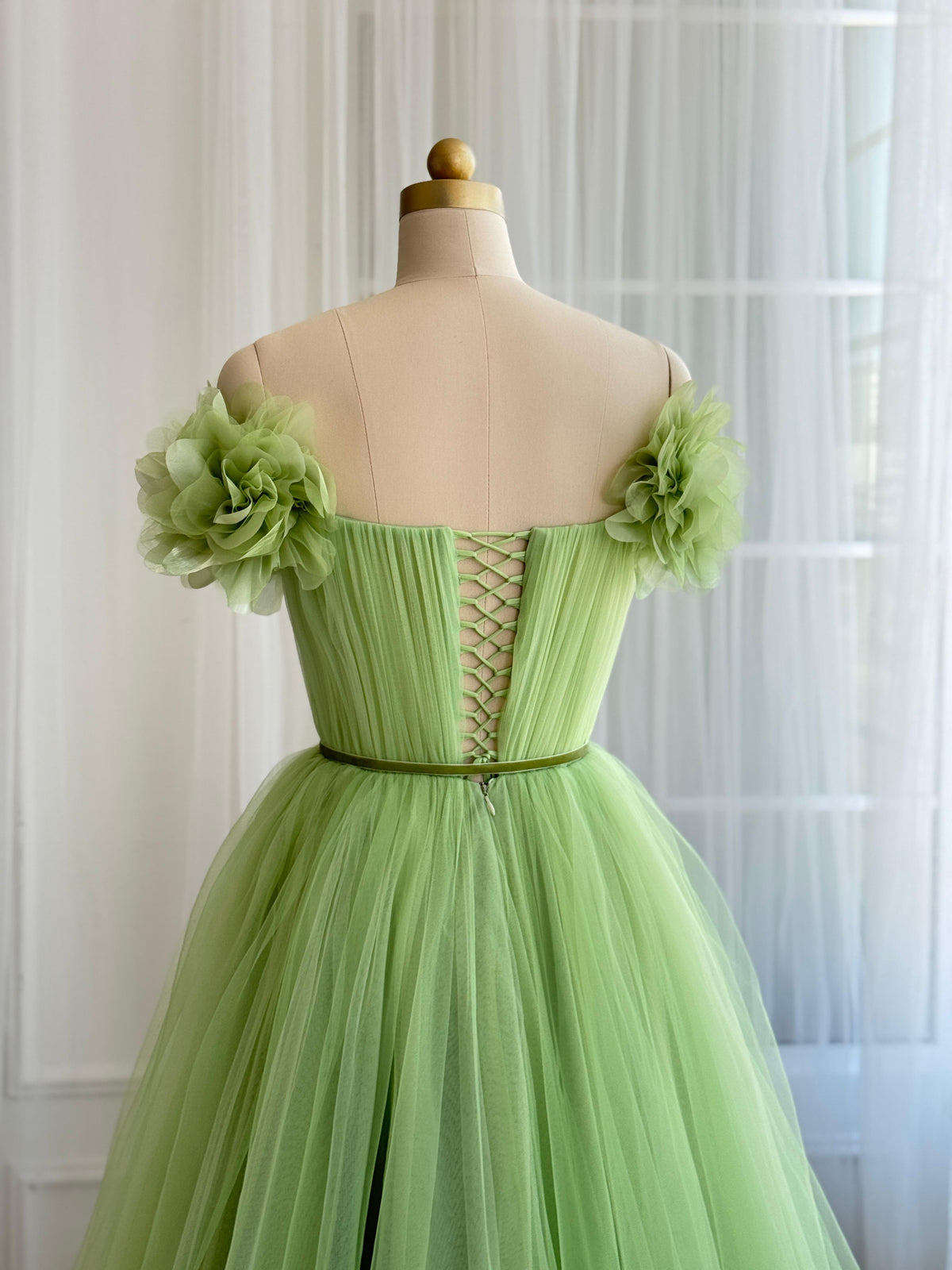 Green A-Line gown with off the shoulder sleeves and embroidered flowers