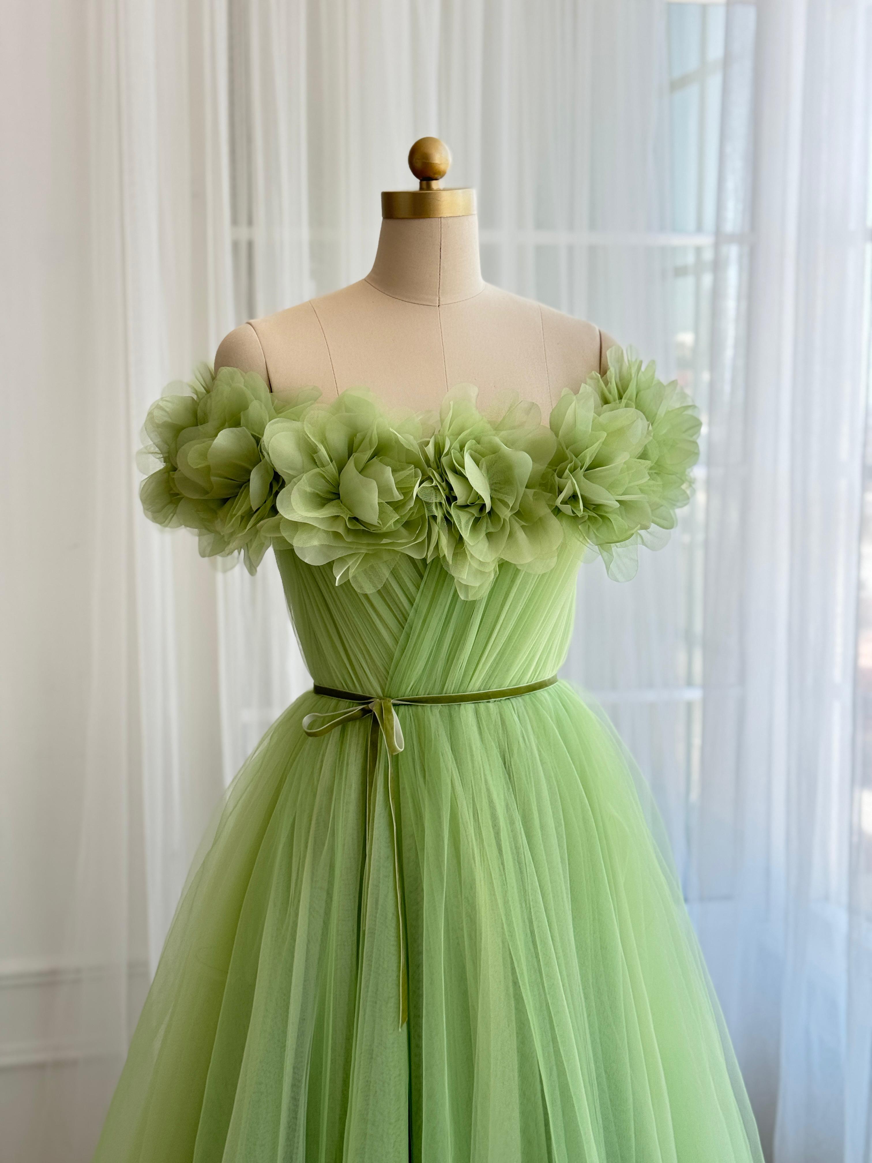 Green A-Line gown with off the shoulder sleeves and embroidered flowers
