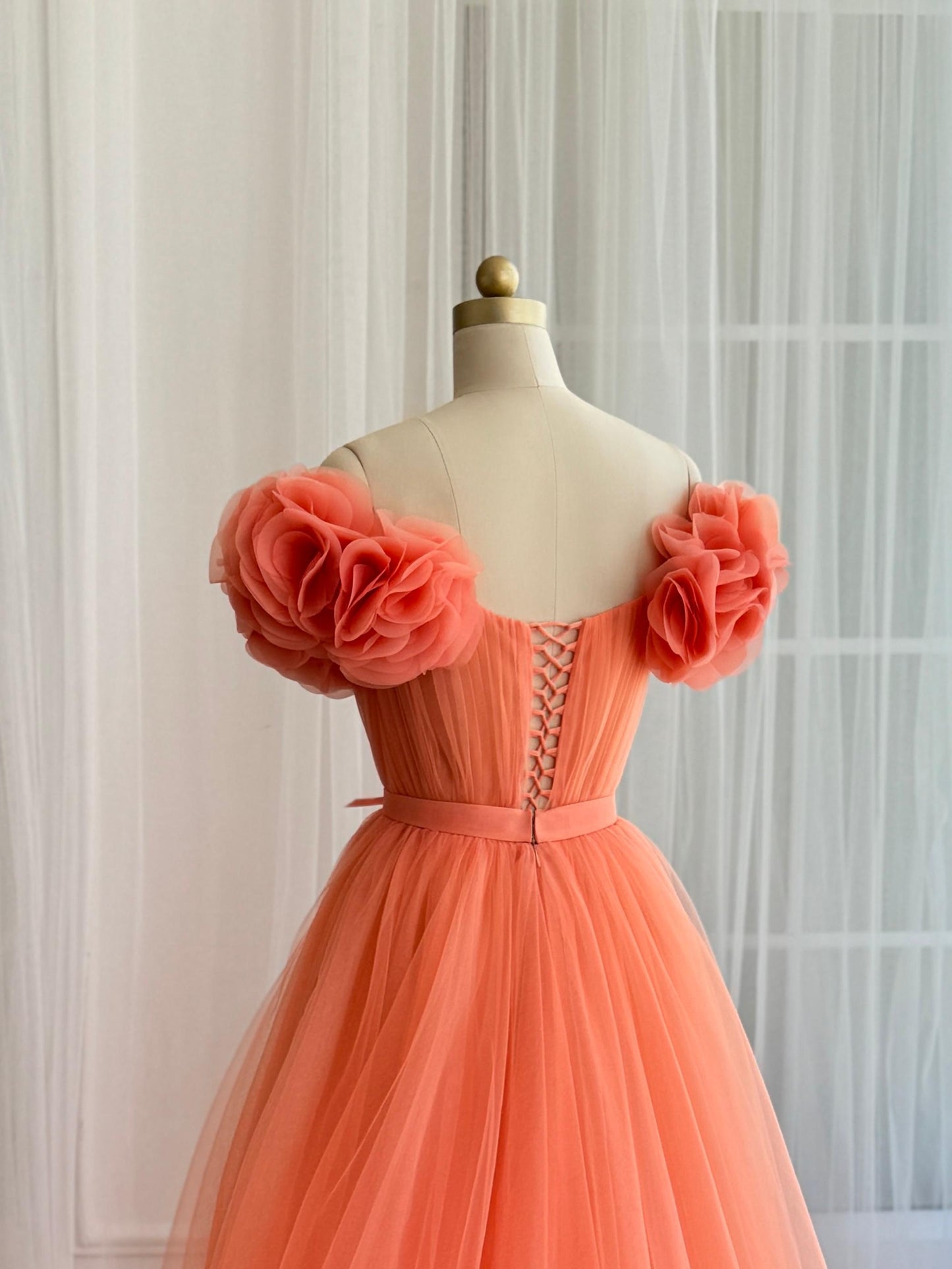 Peach A-Line gown with off the shoulder sleeves and embroidered flowers