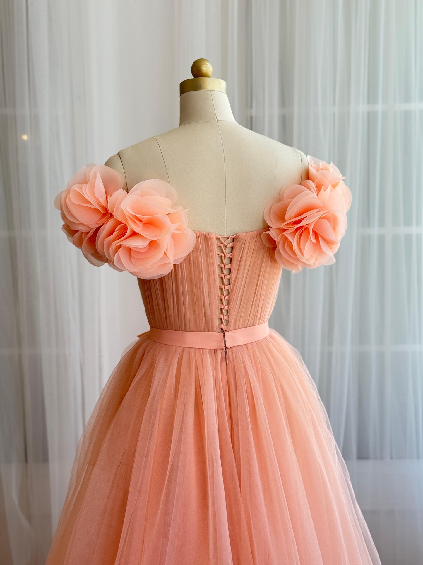 Peach A-Line gown with off the shoulder sleeves and embroidered flowers