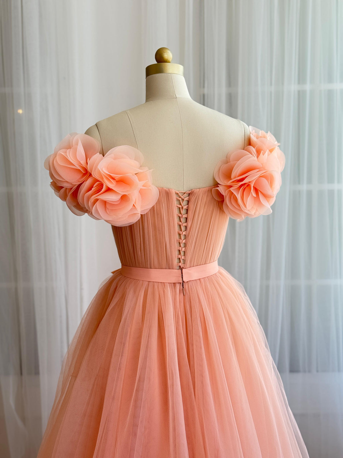Peach A-Line gown with off the shoulder sleeves and embroidered flowers