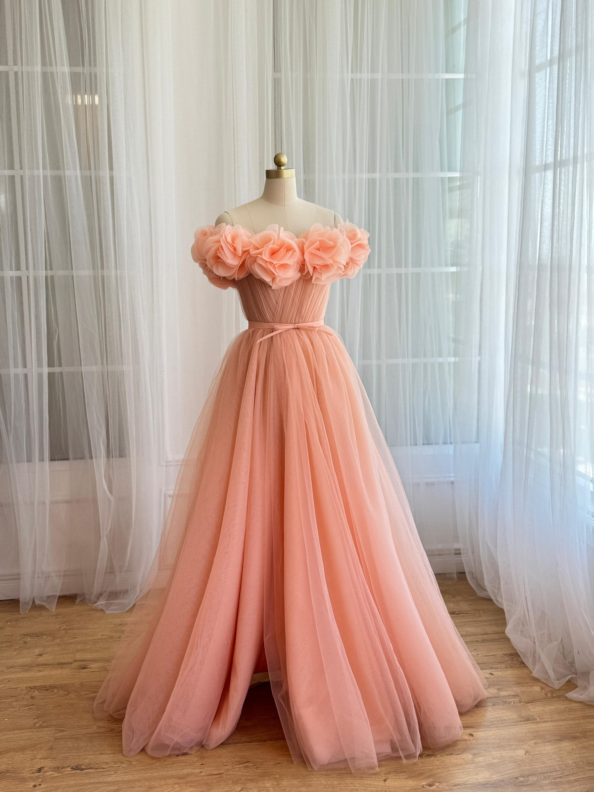 Peach A-Line gown with off the shoulder sleeves and embroidered flowers